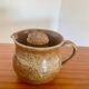 Large antique brown glazed stoneware jug with cork stopper.