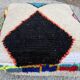 Berber floor pouf: Handwoven Moroccan wool cushion.