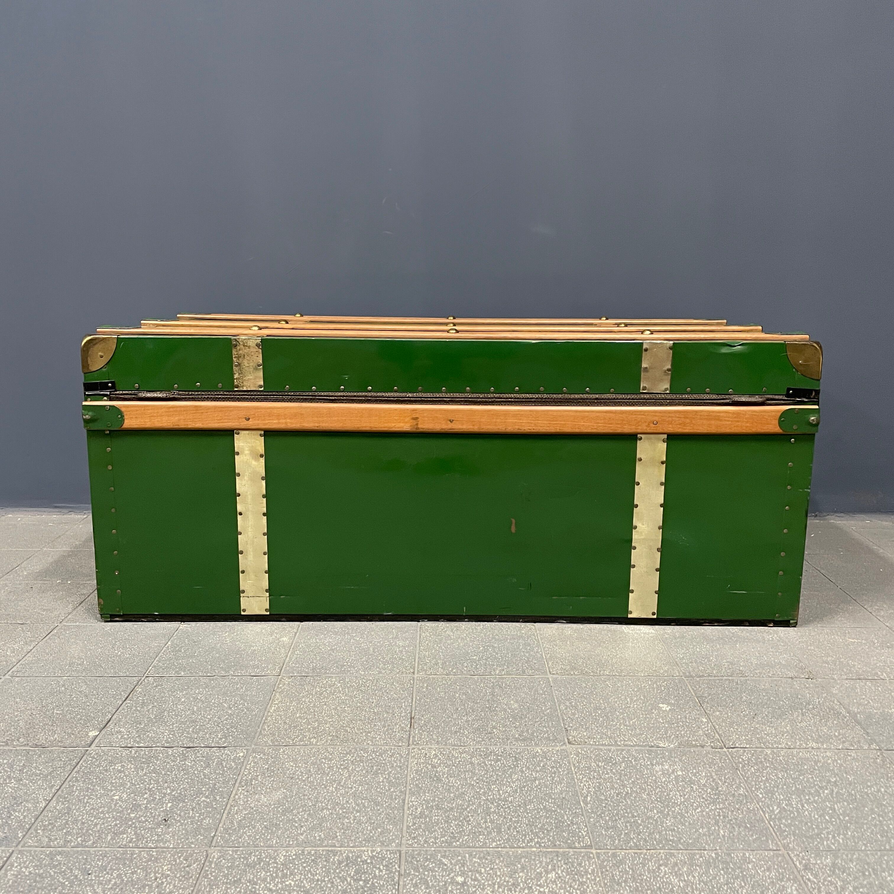 Green metal trunk with wooden sleds
