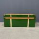 Green metal trunk with wooden sleds