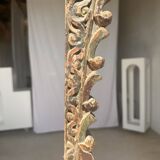 Indonesian construction element in carved wood with intertwined plant motifs mounted on a base (fri