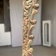 Indonesian construction element in carved wood with intertwined plant motifs mounted on a base (fri