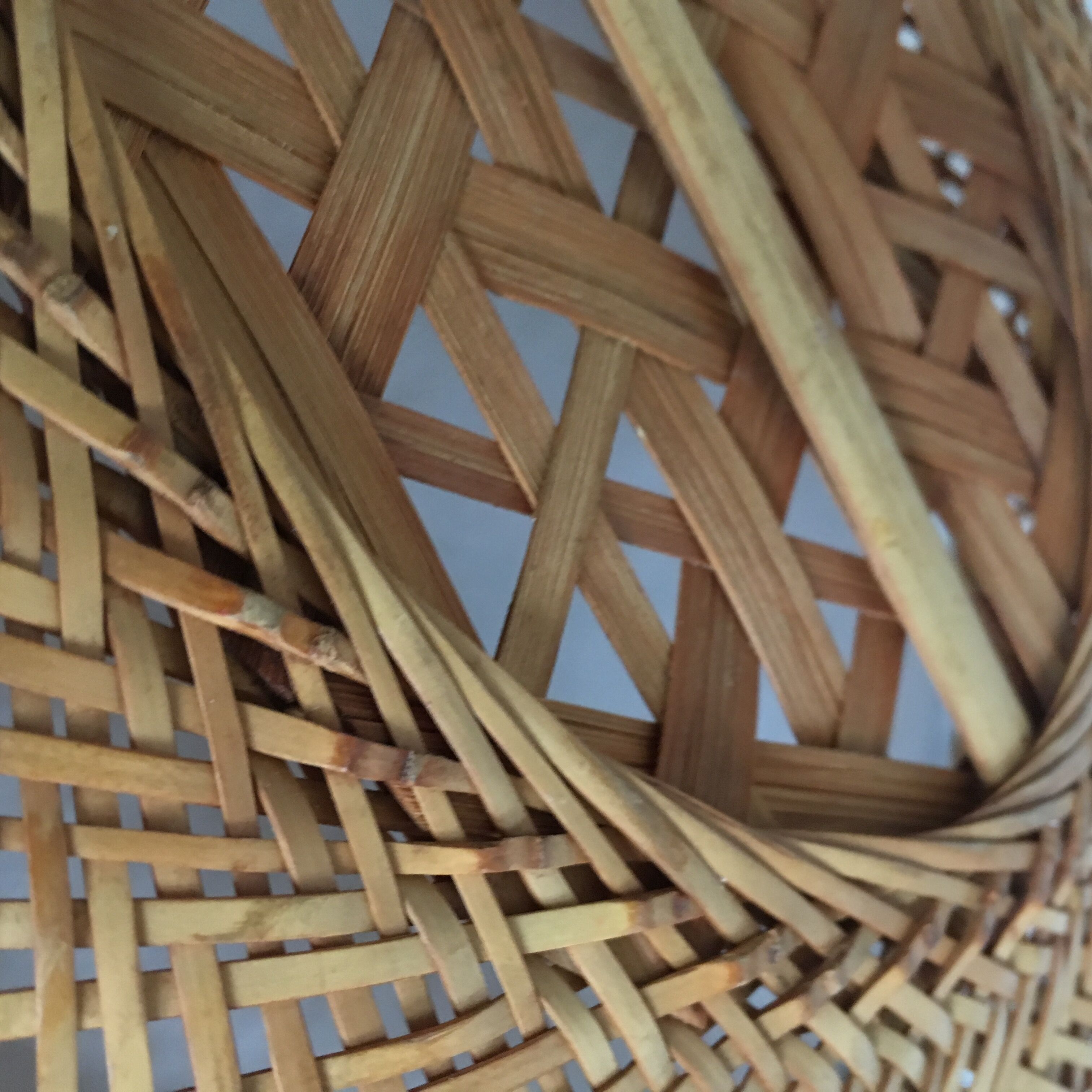 Braces of wood and woven rattan oval basket