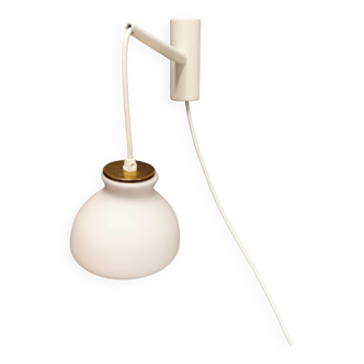 Milky white Holmegaard wall lamp with glass shade and a brass detail on top. Wooden wall bracket