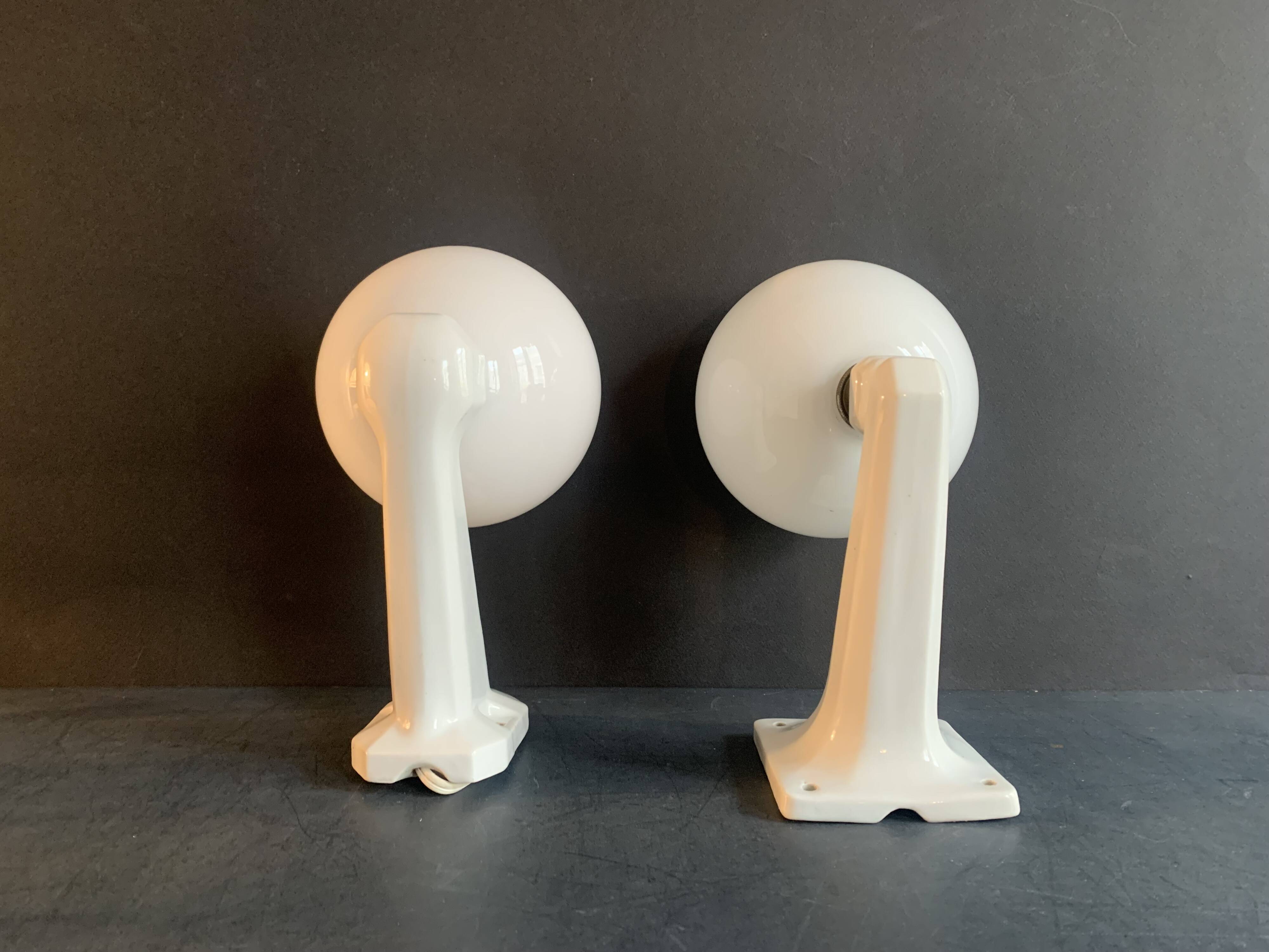 Pair of Art Deco porcelain wall lights with white Opaline globes, 1920
