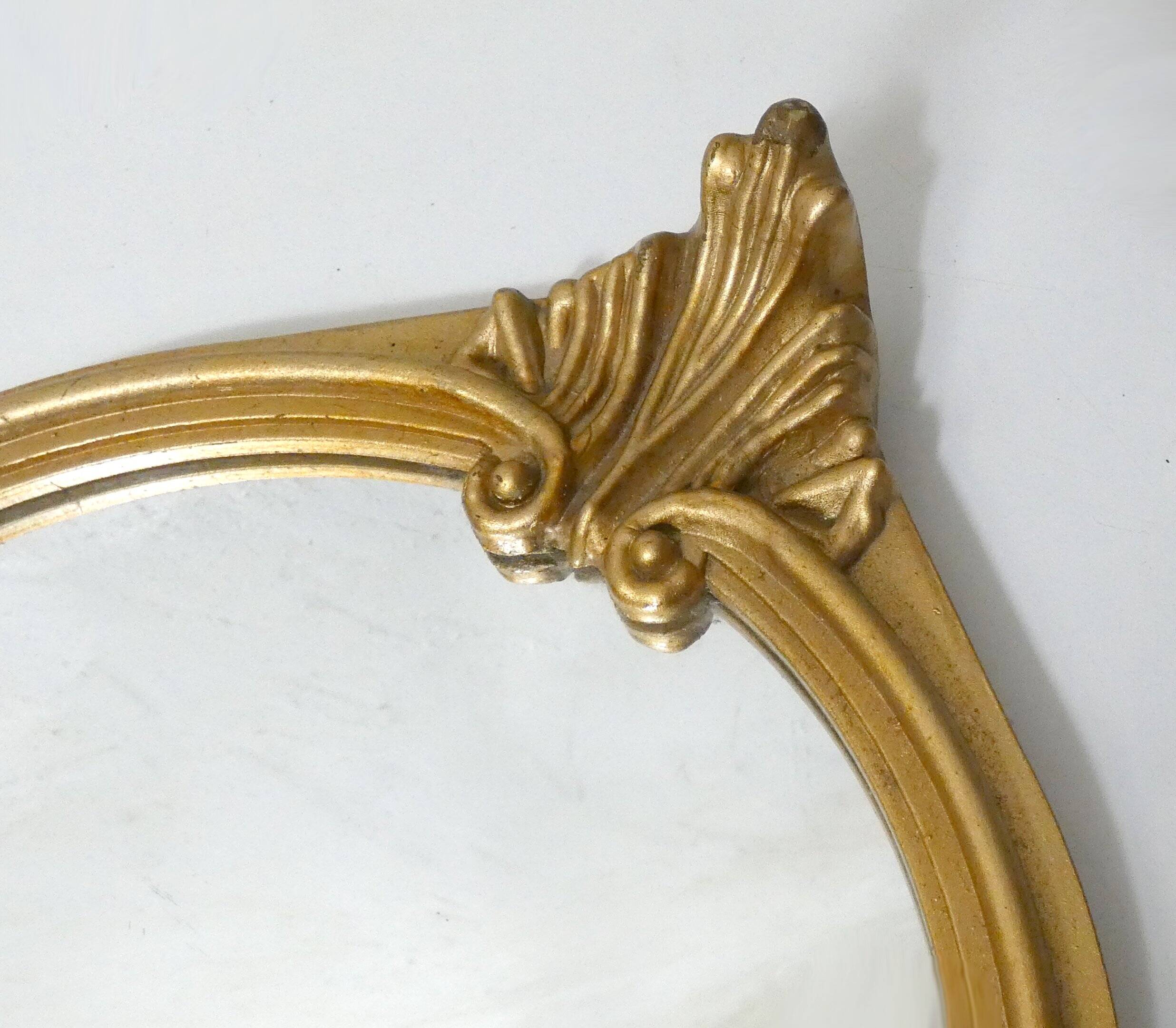 Antique Louis XV style mirror with a vintage carved gold frame.
