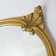 Antique Louis XV style mirror with a vintage carved gold frame.