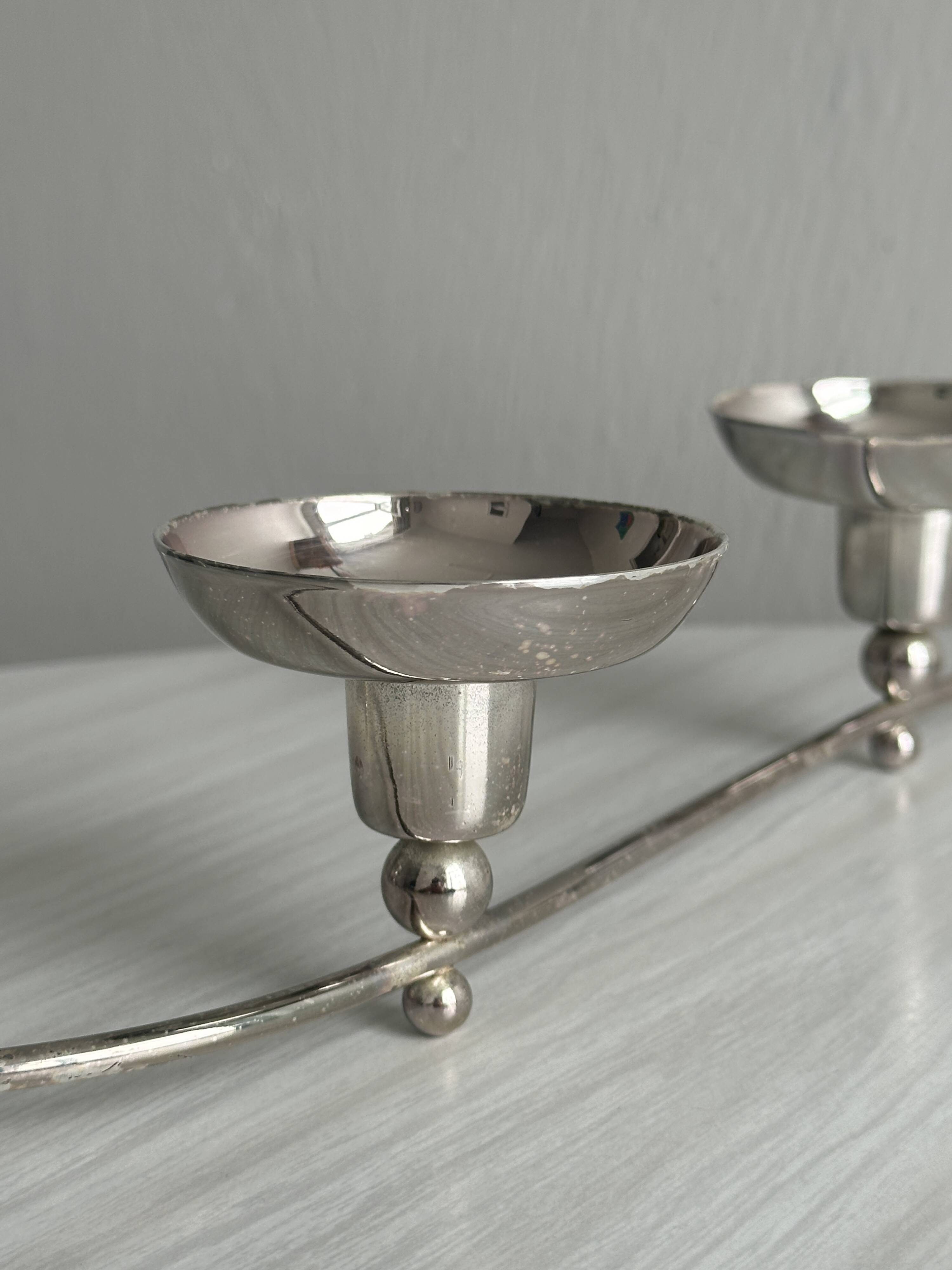 Shiny stainless steel candlestick holder