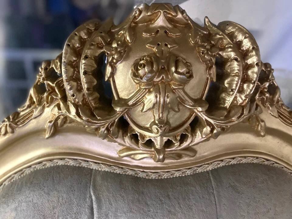 A soft light blue and silver tufted beech wood sofa in Louis style.