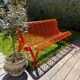Orange pierced sheet metal bench