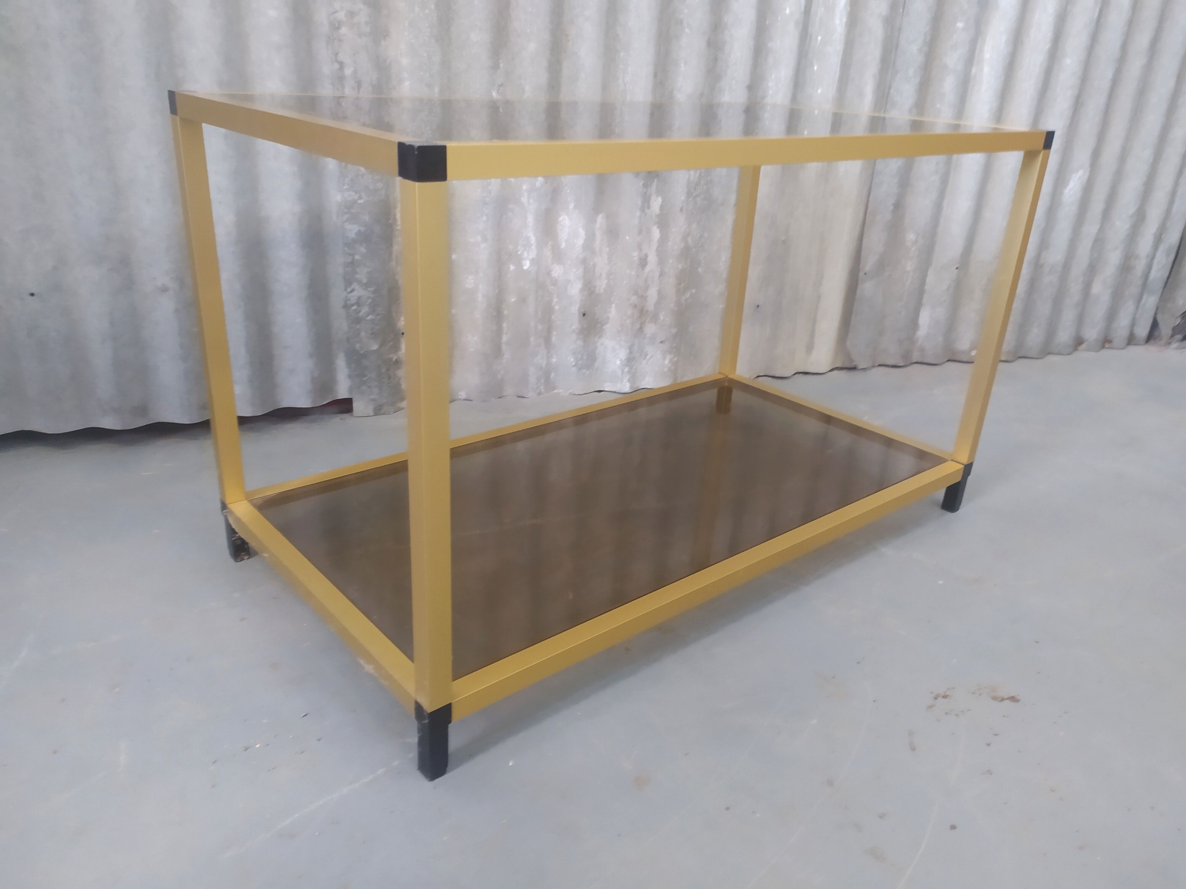 Gold metal coffee table and smoked glass