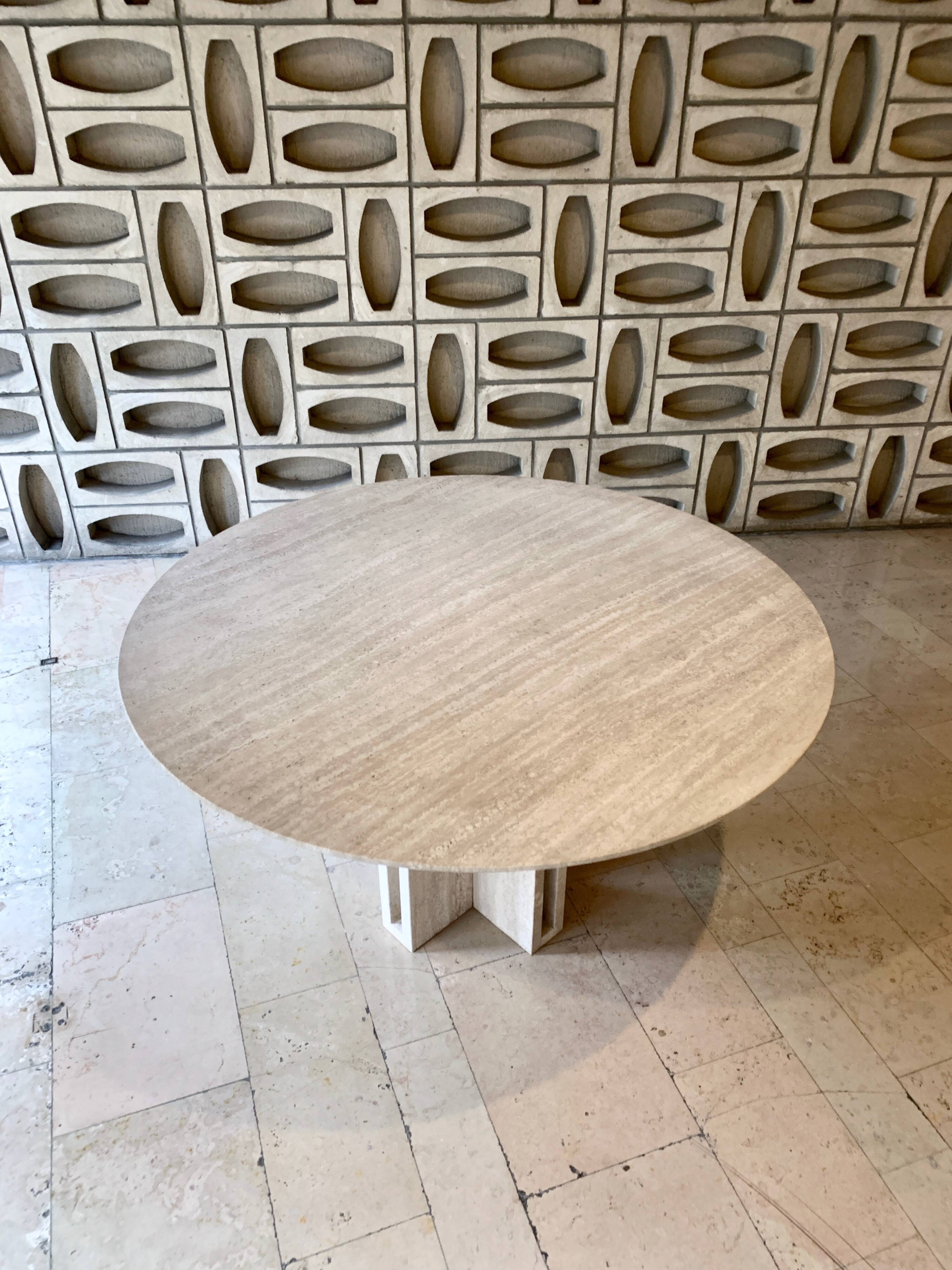 Round travertine dining table by Claude Berraldacci
