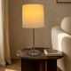Large brushed metal table lamp with an ecru shade.