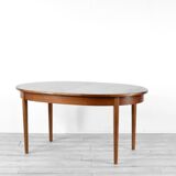 A stylish vintage teak danish influenced extending dining table for sale.  Supported on four slender
