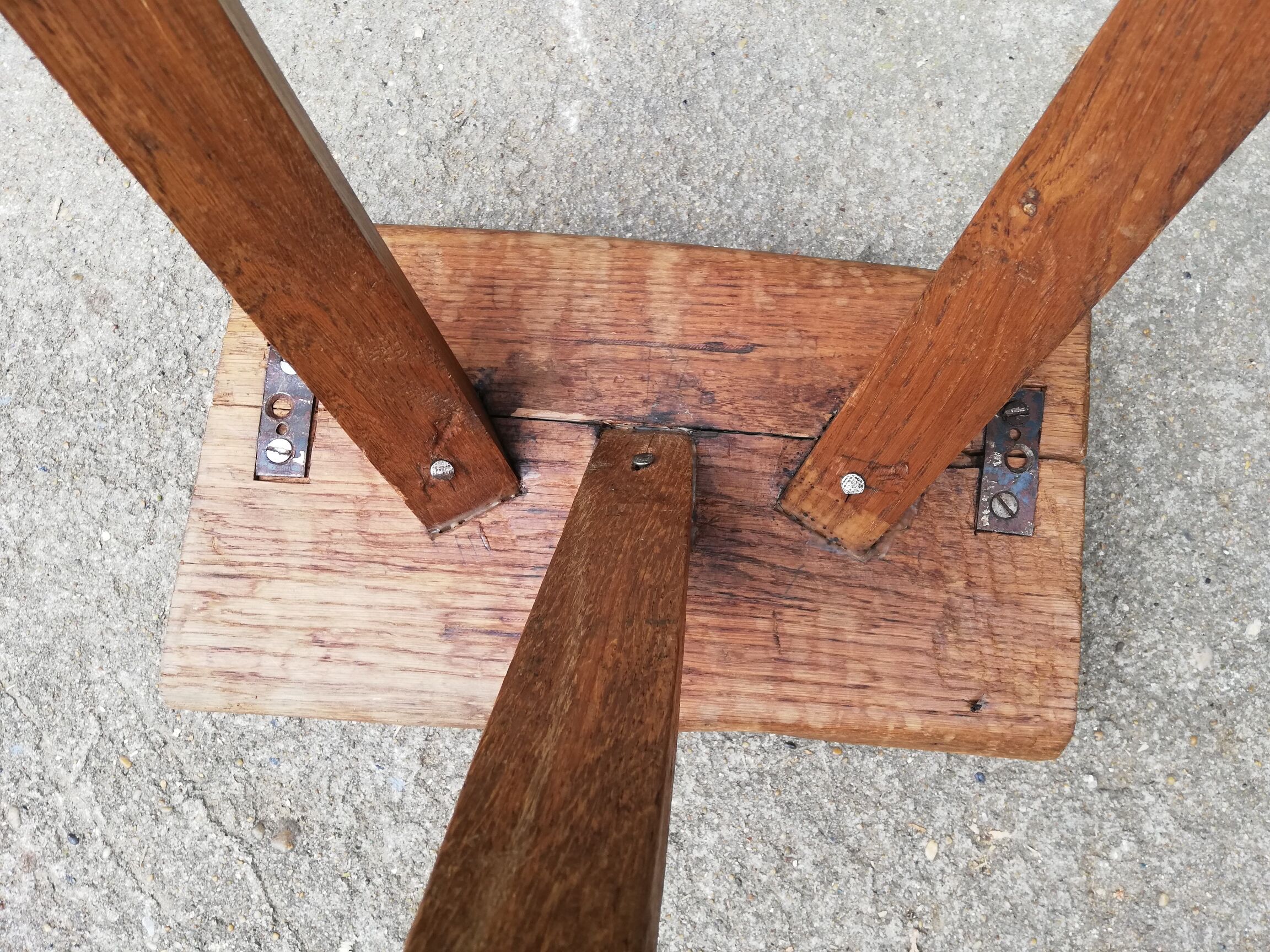 Old farm stool raw wood tripod