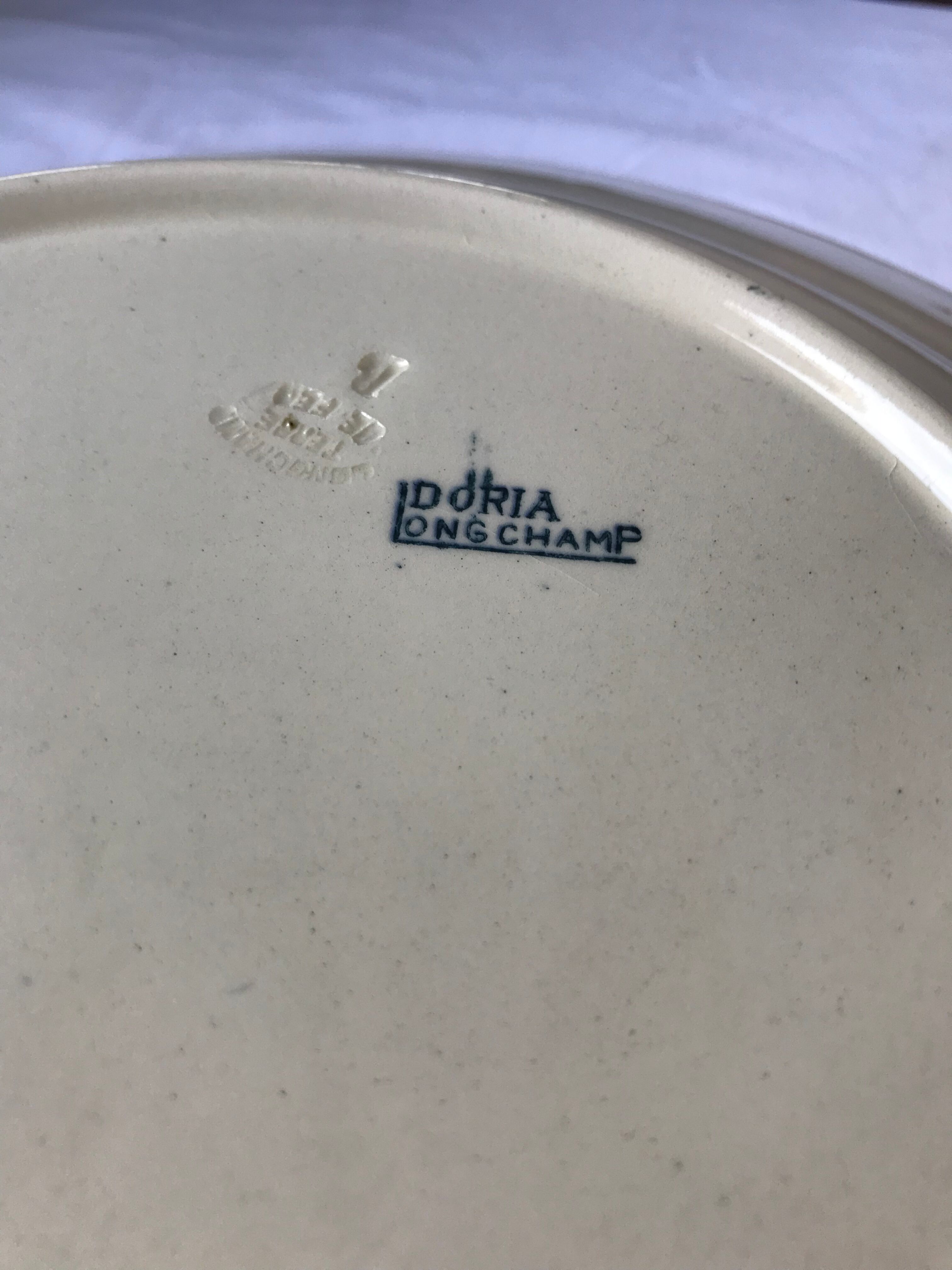 Round serving dish from the Longchamp earthenware factory, Doria model. Iron Land