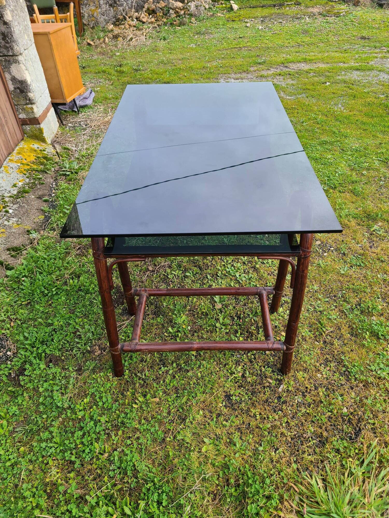 Smoked glass desk on rattan legs and leather detail