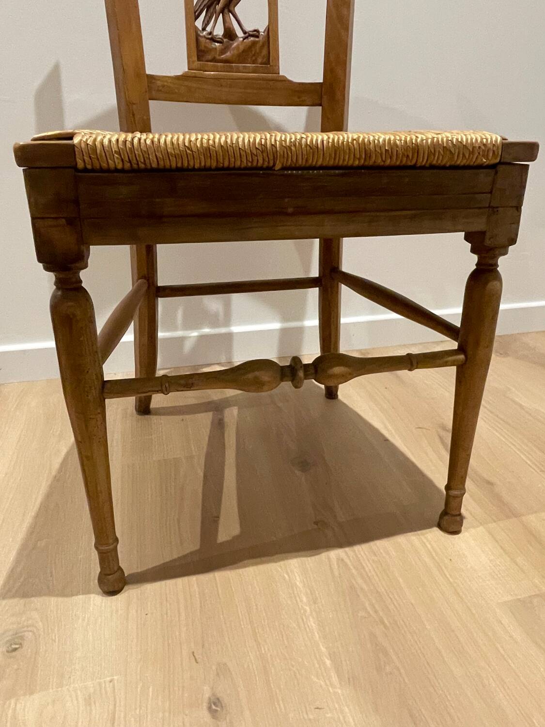 19th century straw chair with carved peacock back