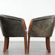 Set of two cowhide and wooden tub chairs with a sturdy colour scheme