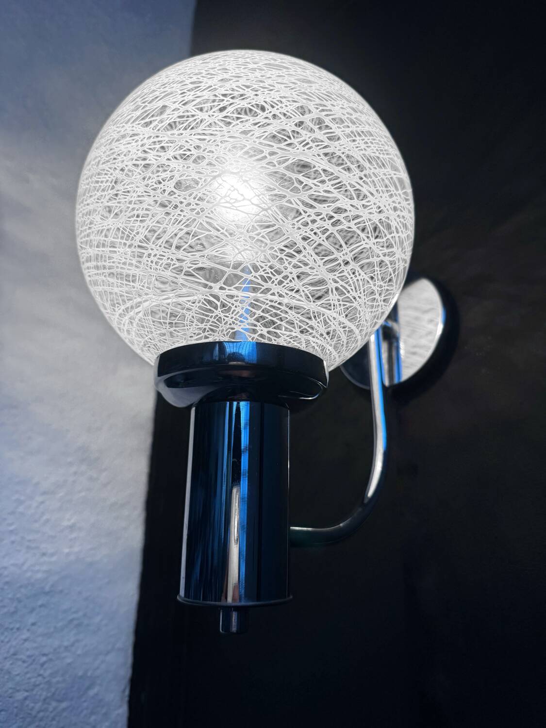 Chrome wall light with blown glass from the 1970s.