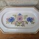 Rectangular earthenware dish with a glazed finish, decorated with a bouquet of flowers.
