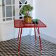 Red metal folding table Malaval type