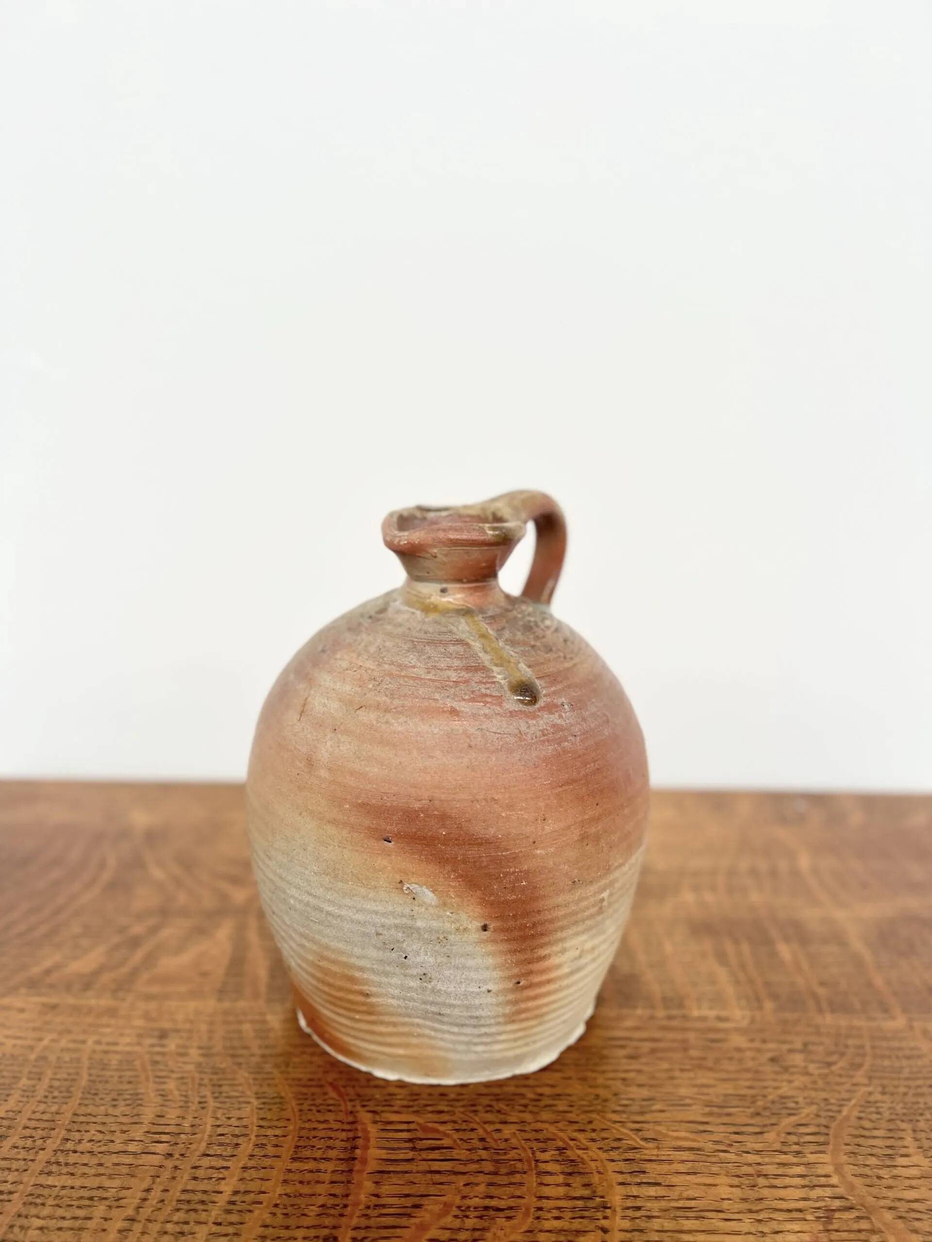 Small antique stoneware jar with handle