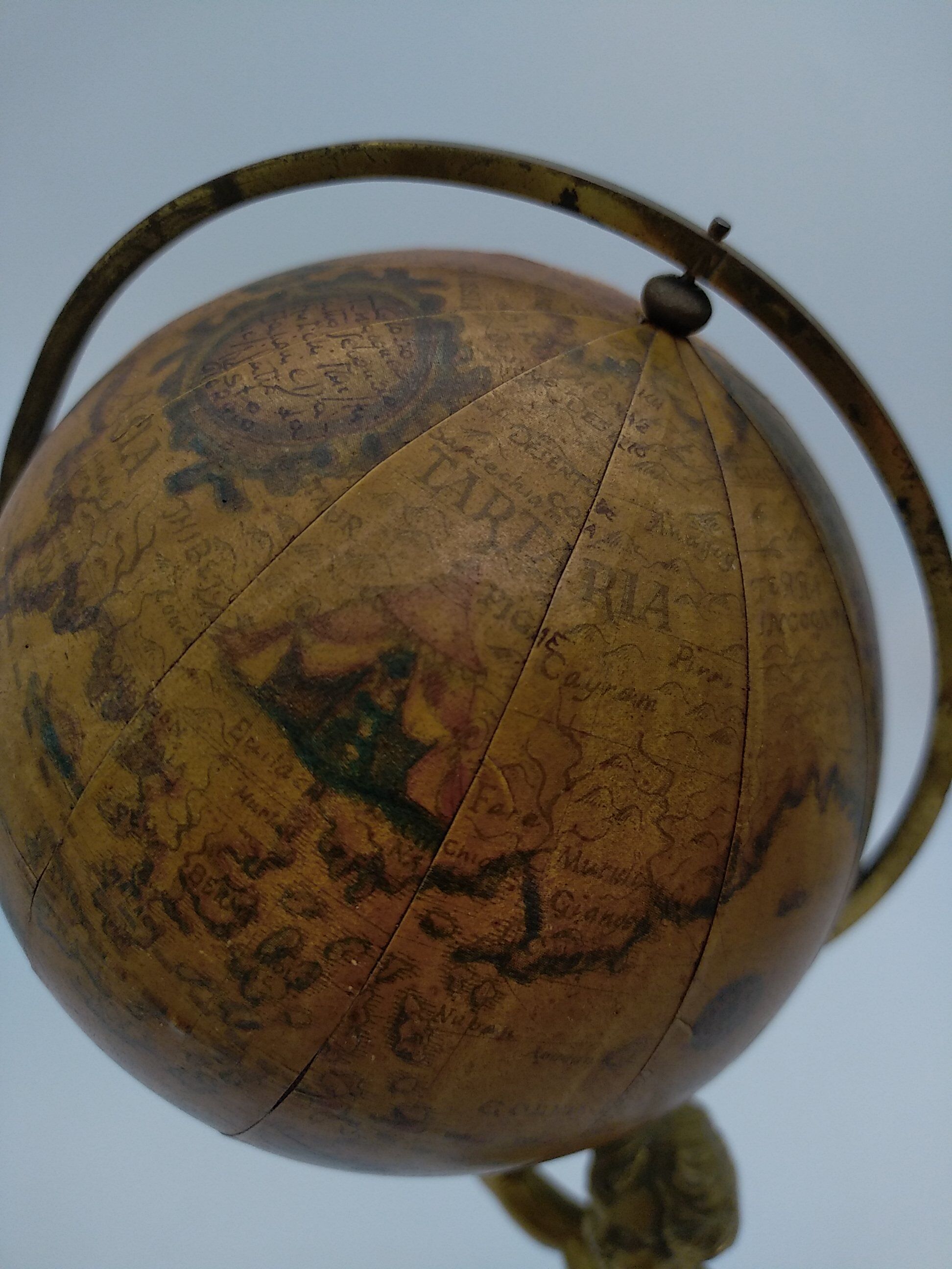 Cherub or putti carrying a globe