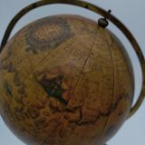 Cherub or putti carrying a globe