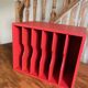 Vintage wooden magazine rack in red.