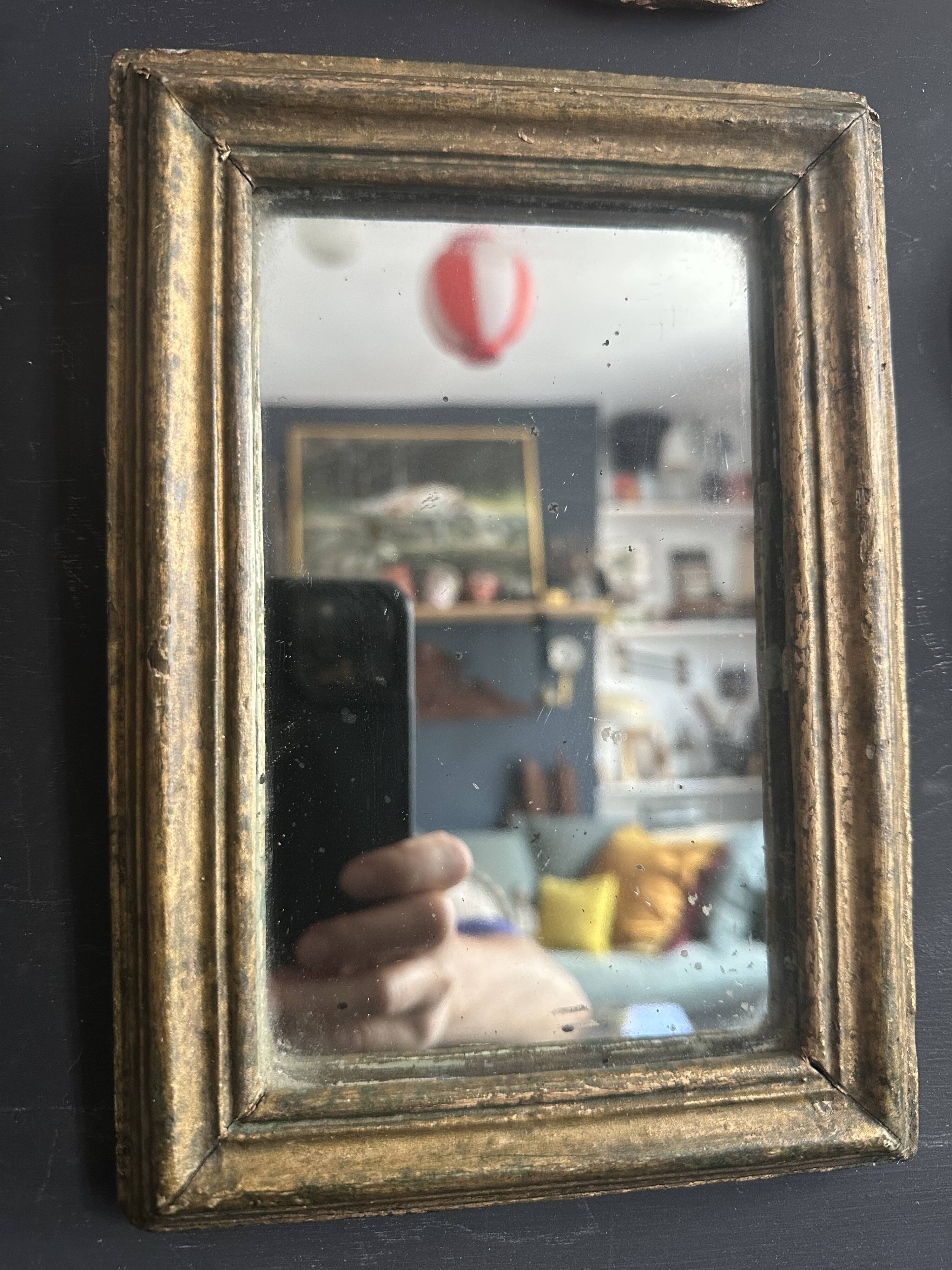 Miniature mirror from the 18th century in gilded wood, mercury glass.