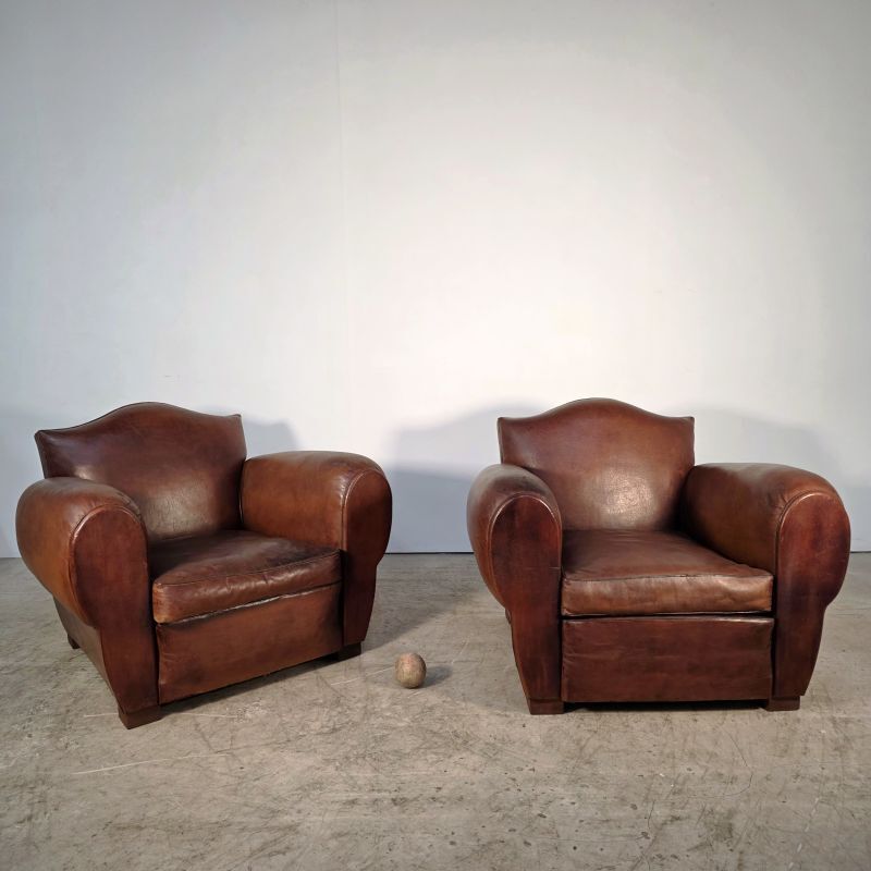 Important pair of Havana leather club armchairs, moustache models, mid-20th century.