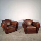 Important pair of Havana leather club armchairs, moustache models, mid-20th century.