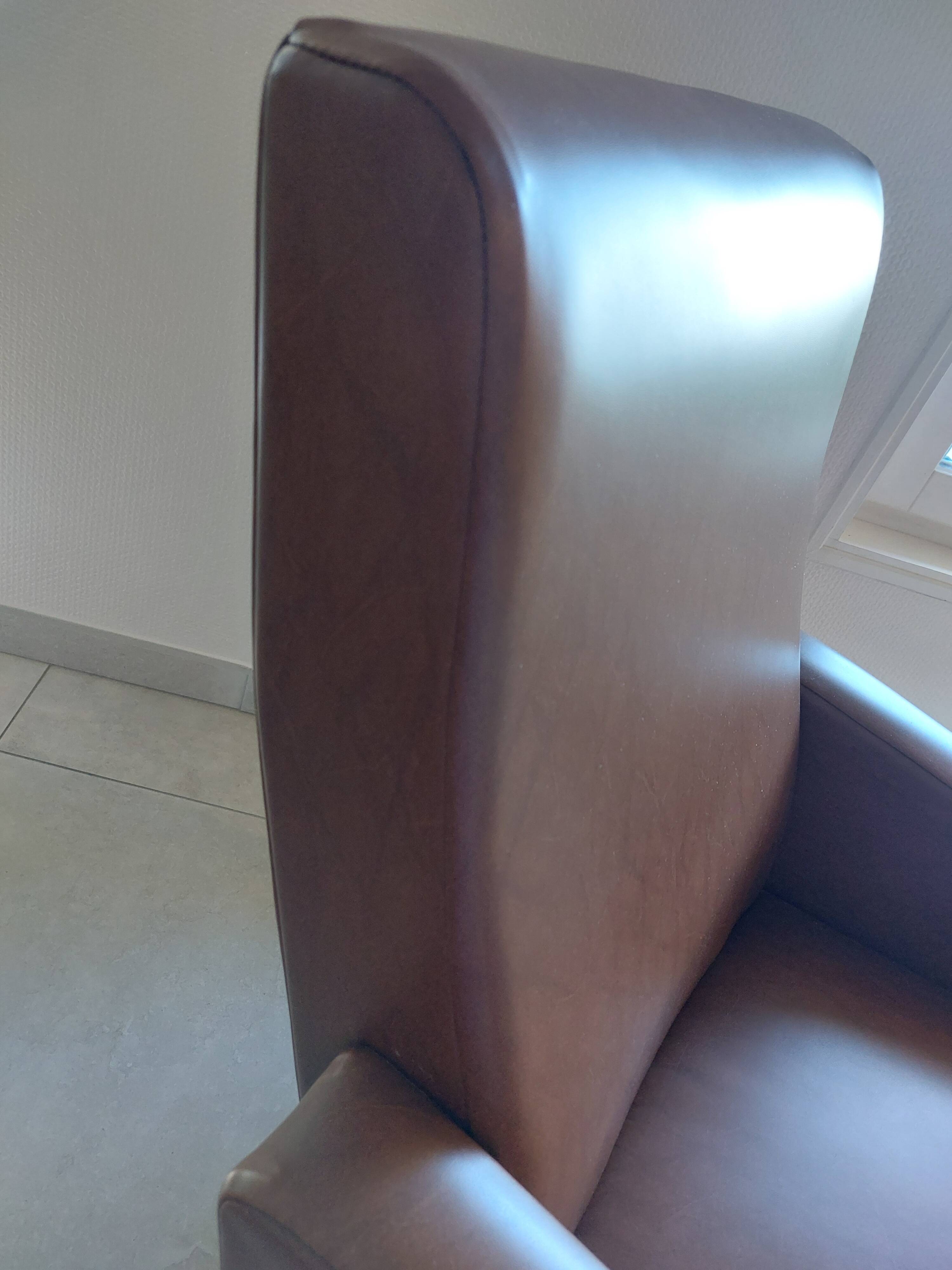 a pair of comfortable vintage armchairs with splayed legs