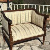 Low armchair in finely carved wood in the Louis XVI style from the 19th century