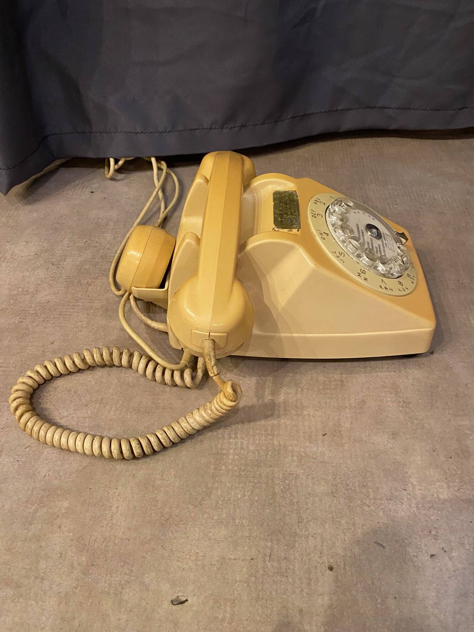 Old dial telephone from the 80s temat quimper bakelite yellow and beige