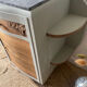 Pair of mismatched art deco bedside tables in green and wood