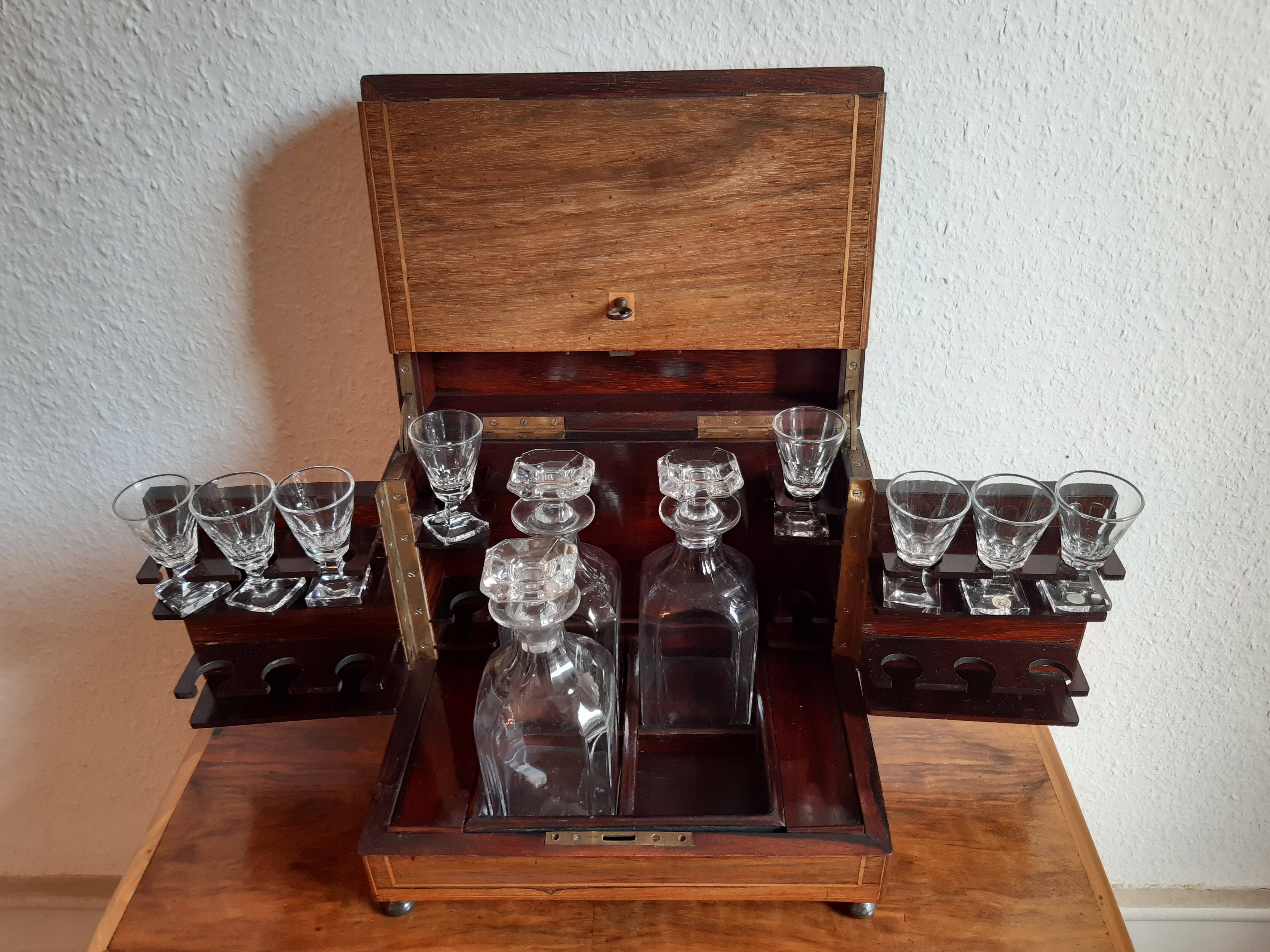Old-fashioned glass liquor cellar and St Louis crystal decanters