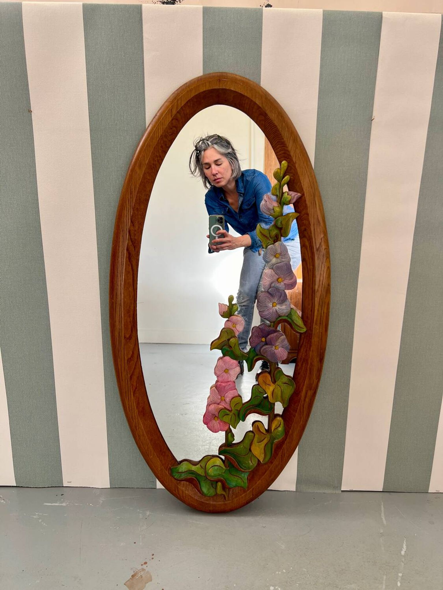 Carved wooden mirror with flower decorations.