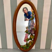 Carved wooden mirror with flower decorations.
