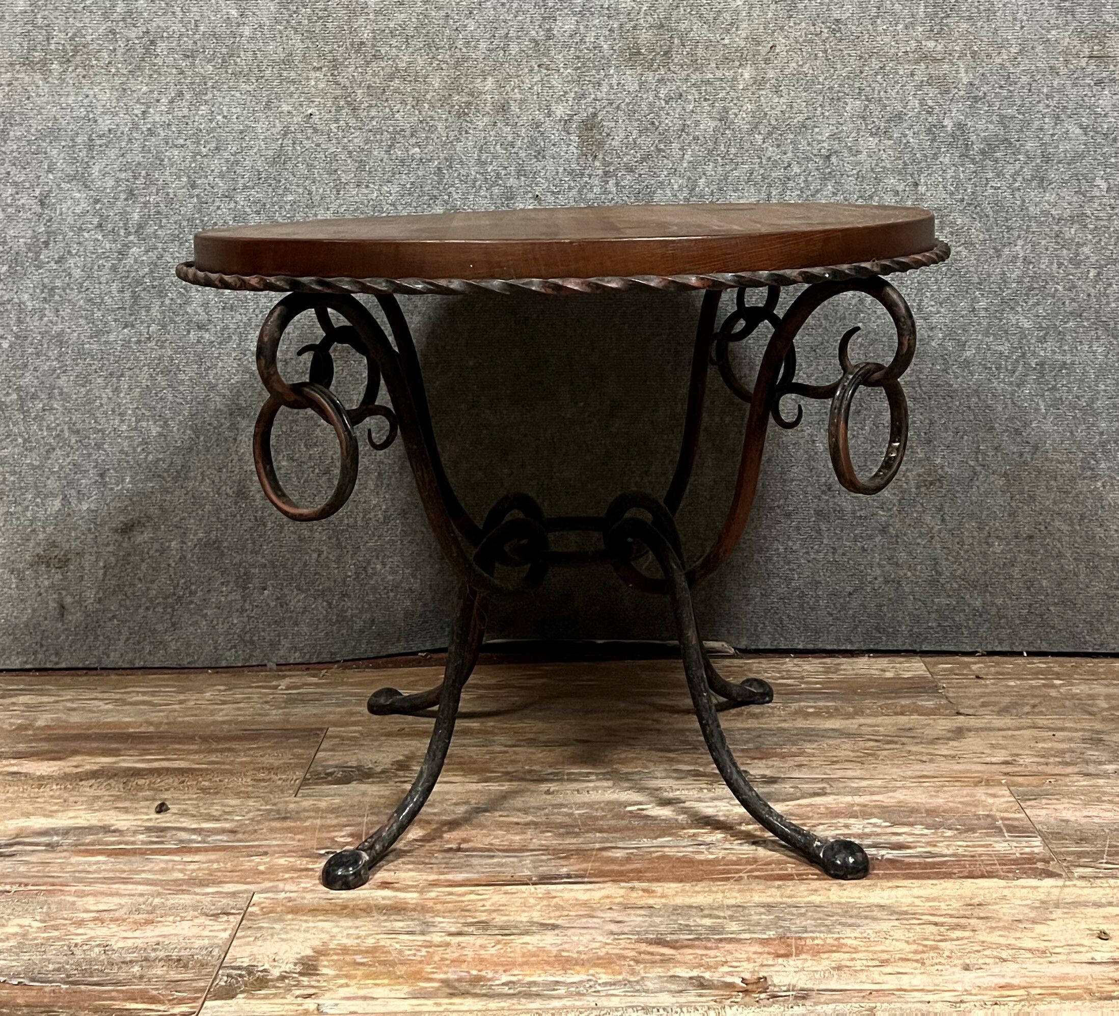 Hammered iron coffee table with circular wooden top