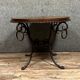 Hammered iron coffee table with circular wooden top