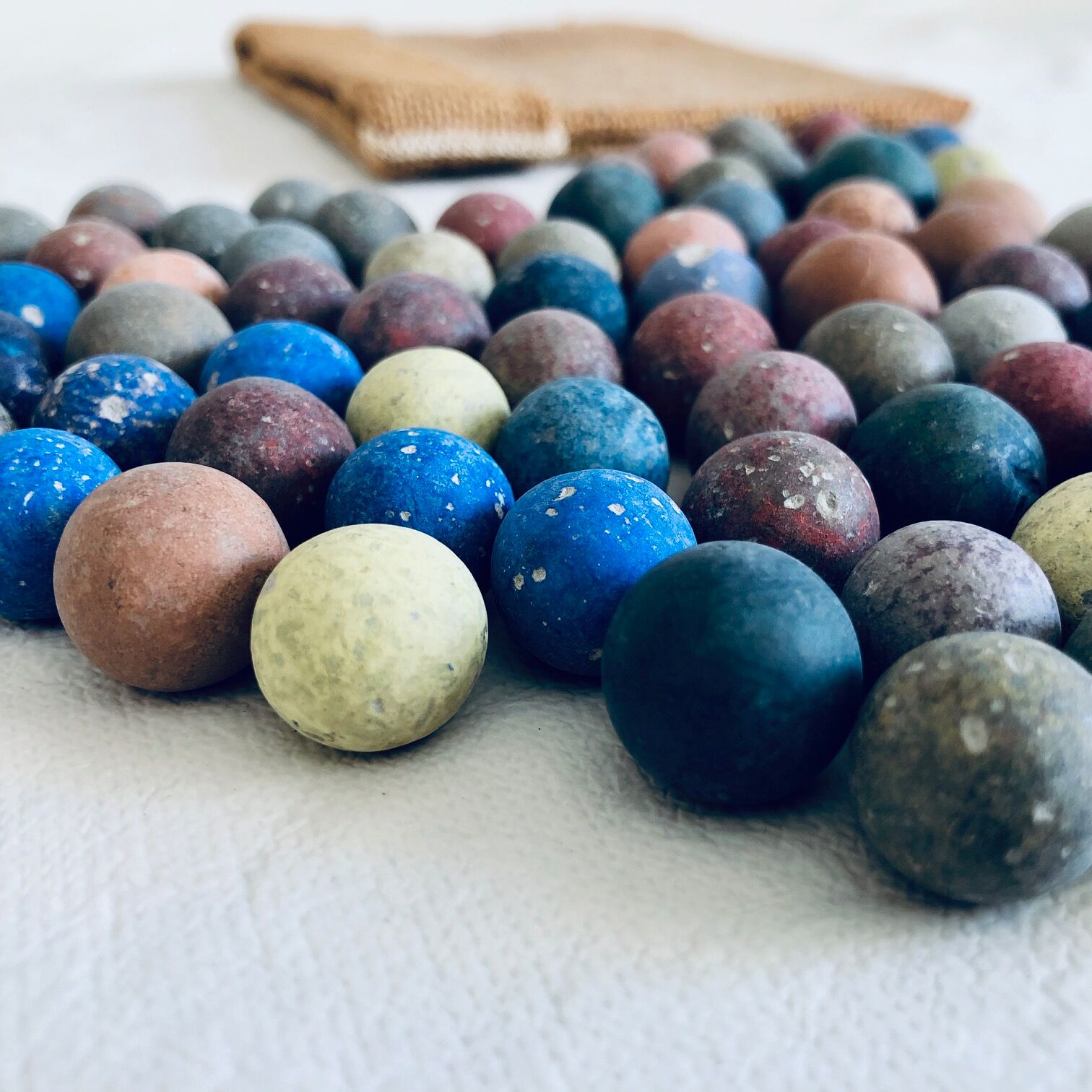 70 clay marbles and burlap bag