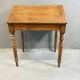 Vintage wooden writing desk with drawer, turned legs, classic style.