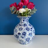 Blue and white ceramic vase with floral pattern in the shape of a vintage ball