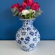 Blue and white ceramic vase with floral pattern in the shape of a vintage ball