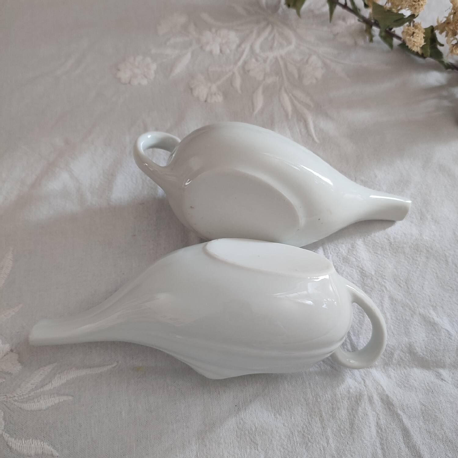 Duo of old white porcelain sauce boats for sick baby bottles