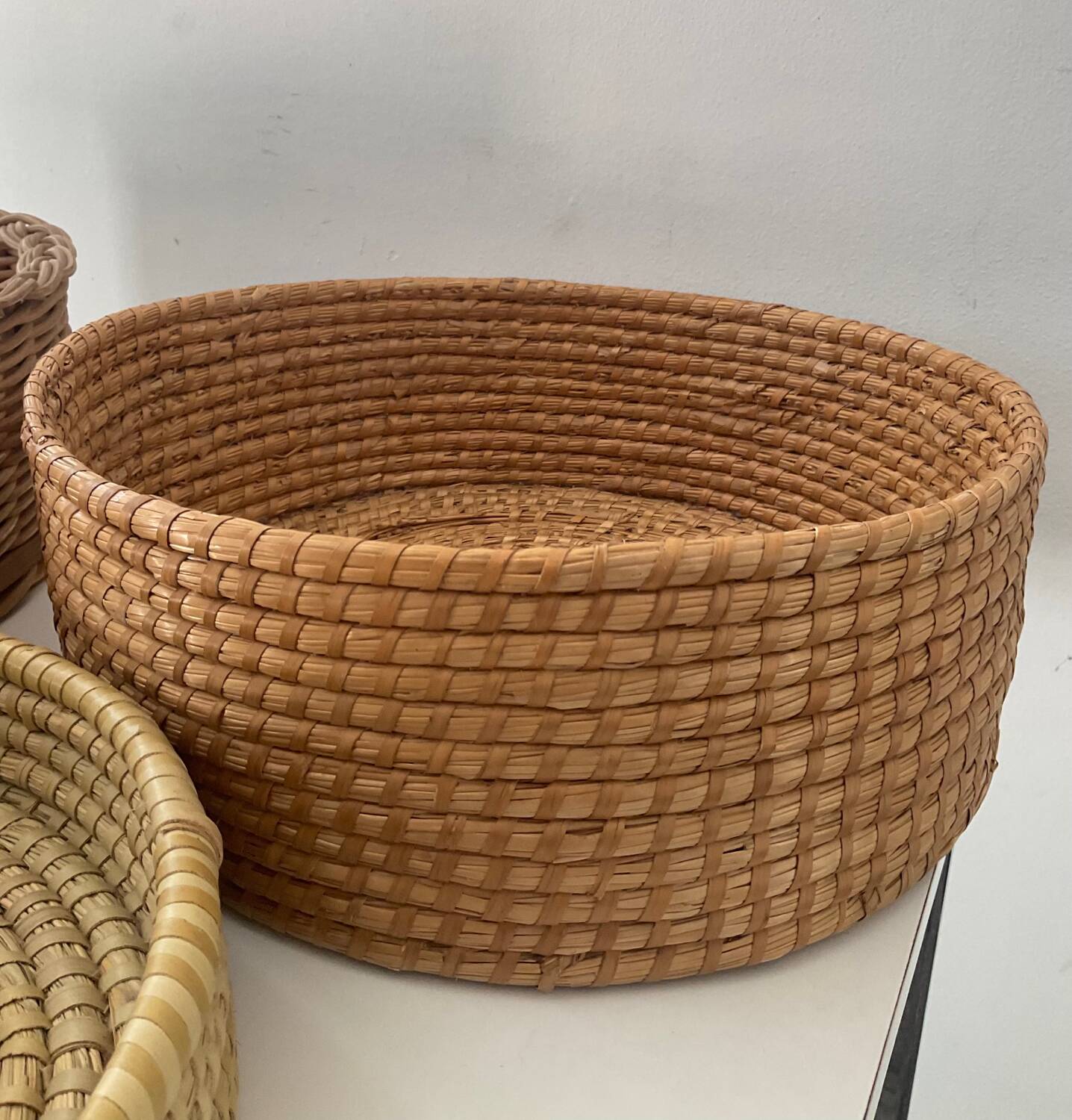 Trio of vintage wicker and woven raffia baskets