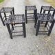 5 blackened wooden stools with woven leather seats by Nina Kaufmann