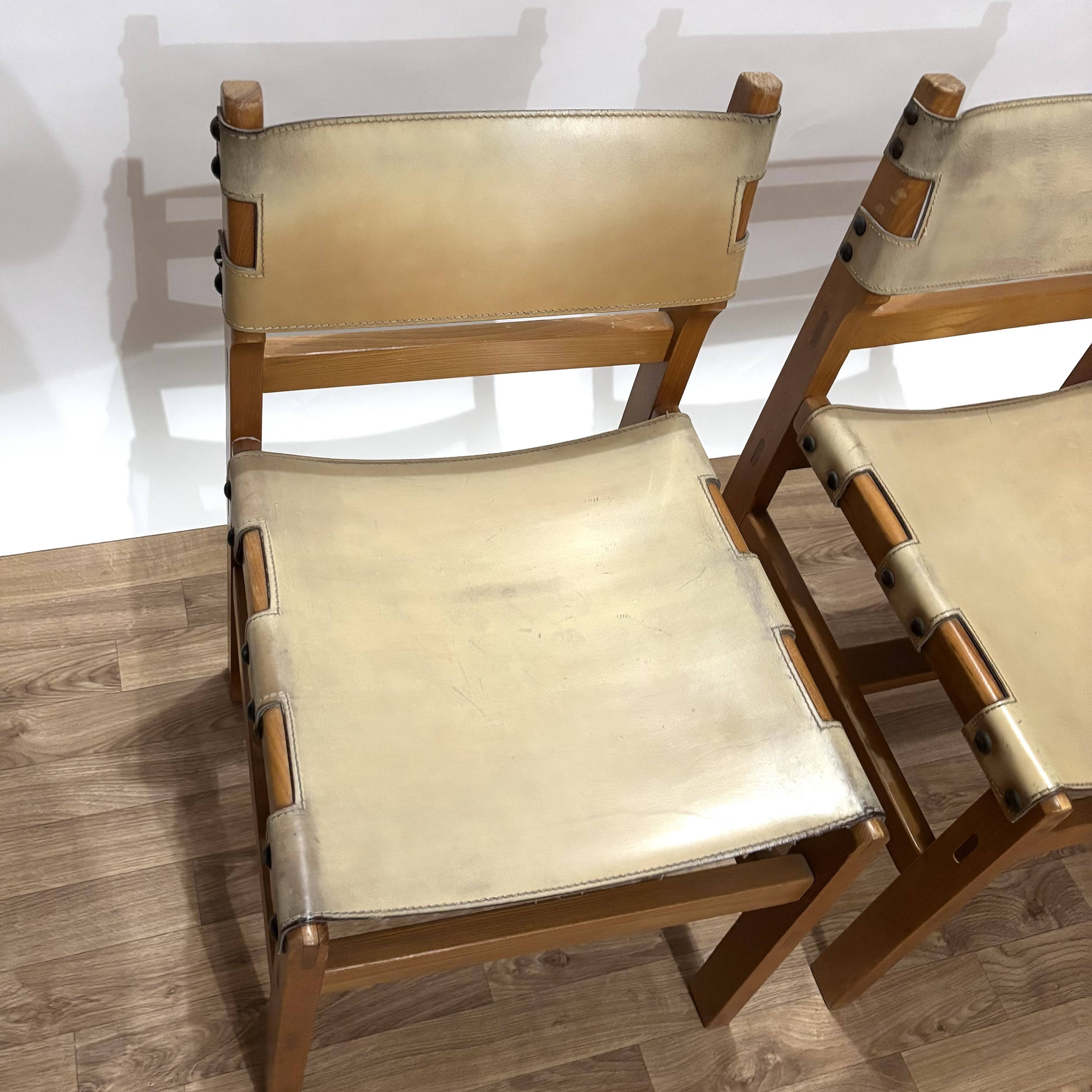 Pair of Maison Regain leather chairs
